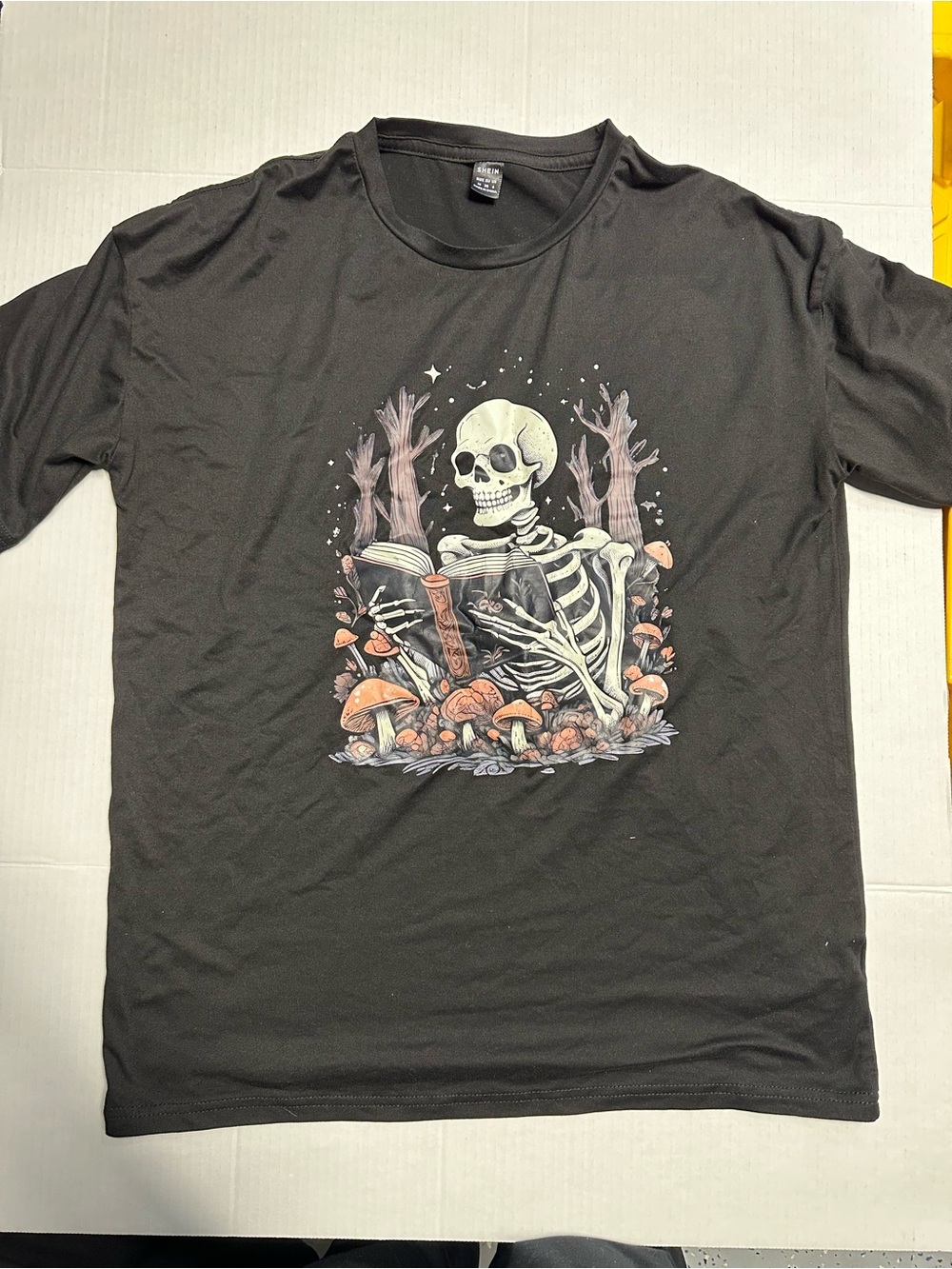 SHEIN Black Tee with Skeleton Reading Among Mushrooms
